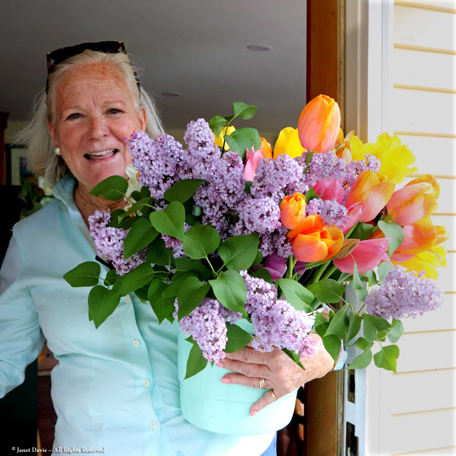 Kathleen Ladd with bouquet of lilacs and tulips from Shirley Williams's garden.